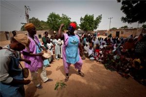 Papa Lolos (Village clowns) are actively engaged during campaign flag offs to draw out the crowds while vaccination team waits to capture all eligible children. UNICEF