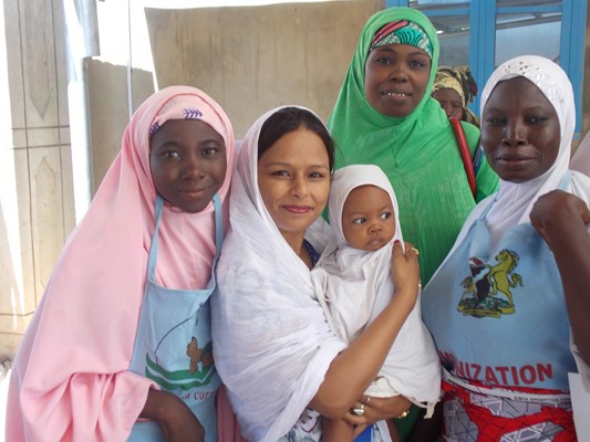 STOP consultant Deepali Sharma with local health workers, baby Zainab and Zainab’s mother. Photo courtesy of Deepali Sharma and CDC